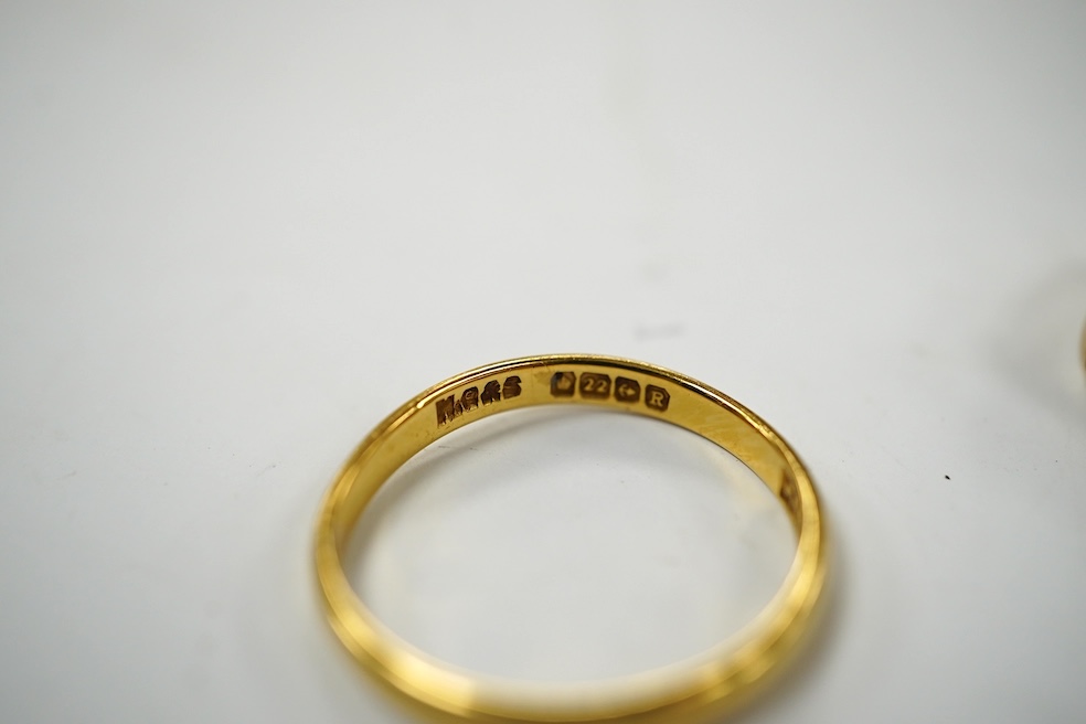 A modern 9ct gold buckle ring, 2.2 grams and a 22ct gold wedding band, 1.6 grams. Condition - poor